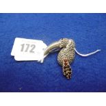 A SILVER MARCASITE AND GARNET TOUCAN BROOCH