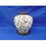 JAPANESE CLOISONNE VASE, OF SQUAT BALUSTER FORM, THE PURPLE GROUND DECORATED WITH BLOSSOMING TREES,