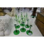 A SET OF EIGHT ACID ETCHED TALL GREEN STEM HOCK GLASSES AND A SET OF SIX TALL STEM GREEN GLASSES