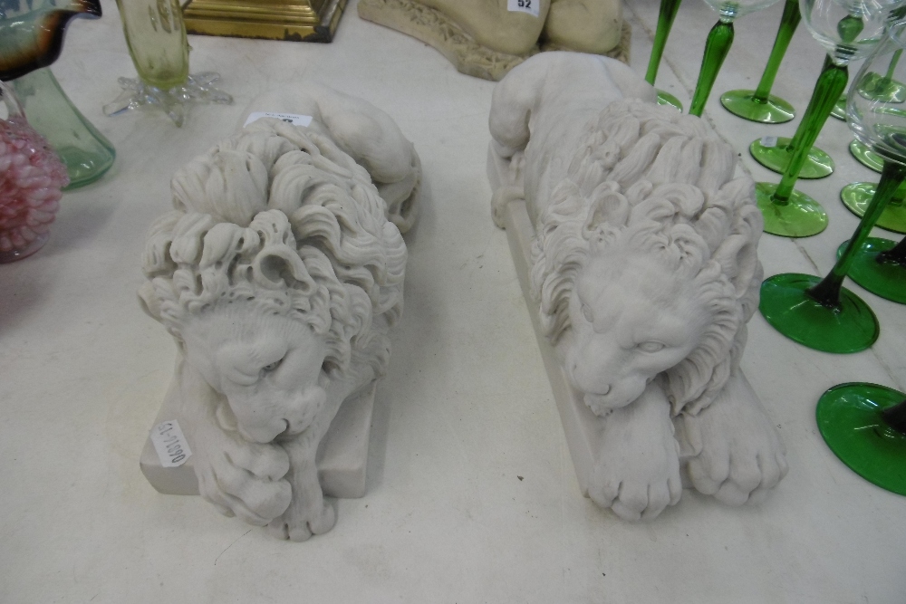 A PAIR OF RECUMBENT LIONS