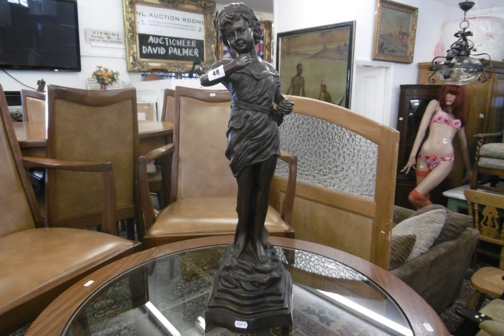 A BRONZE SCULPTURE OF A GIRL