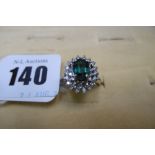 A 14CT GOLD DIAMOND AND EMERALD CLUSTER RING