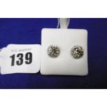 A PAIR OF CHAMPAGNE DIAMOND STUD EARRINGS WITH WHITE DIAMOND HALLO EACH STONE OVER 1CT