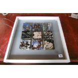 A FRAMED AND GLAZED COLLECTION OF ART TILES