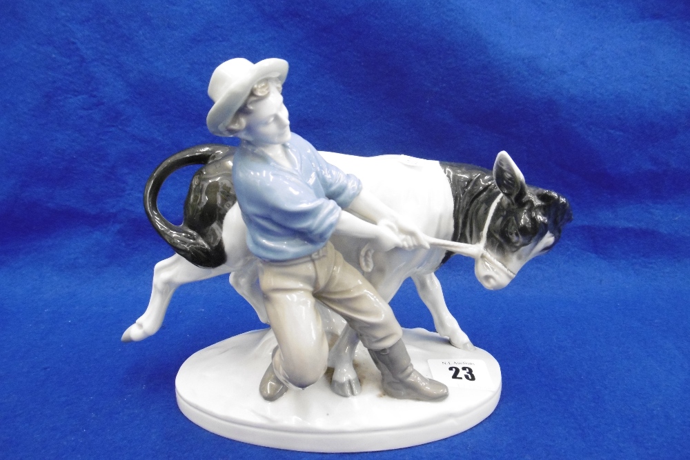 A MARK QUERY PORCELAIN FIGURINE FARMER PULLING A COW