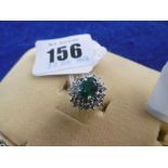 A 14CT GOLD DIAMOND AND EMERALD CLUSTER RING