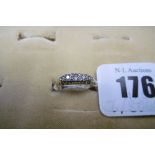 A GOLD FIVE STONE DIAMOND HALF HOOP RING