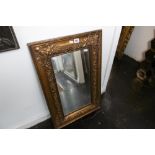 A GILT FRAMED MIRROR