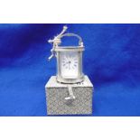 A SILVER PLATED MINIATURE CARRIAGE CLOCK IN BOX