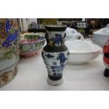 AN ORIENTAL SMALL BLUE AND WHITE VASE A/F