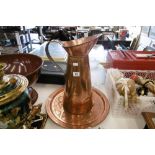 A COPPER JUG AND A DECORATIVE COPPER PLATE