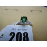 AN 18CT HALO MOUNT GREEN GARNET AND DIAMOND RING,