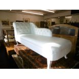 AN UPHOLSTERED CHAISE LOUNGE