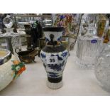 AN ORIENTAL SMALL BLUE AND WHITE VASE A/F