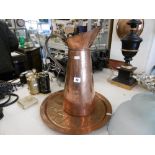 A COPPER JUG AND A DECORATIVE COPPER PLATE