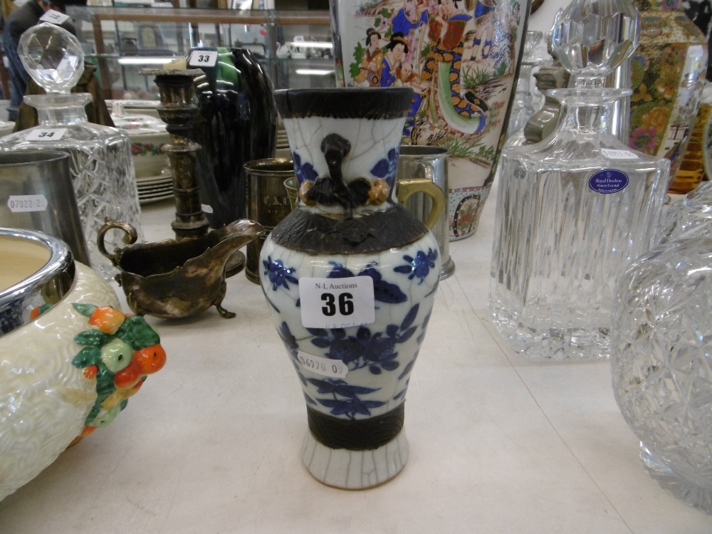 AN ORIENTAL SMALL BLUE AND WHITE VASE A/F