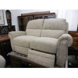 AN ELECTRIC RECLINING TWO SEATER SOFA