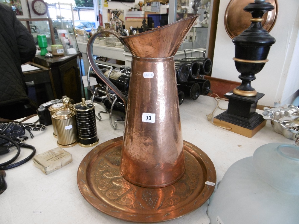 A COPPER JUG AND A DECORATIVE COPPER PLATE