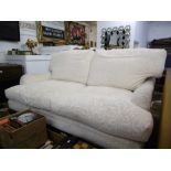 A WHITE UPHOLSTERED TWO SEATER SOFA