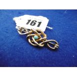 TURQUOISE SET BROOCH IN 9ct GOLD IN A SHAPE OF A KNOT