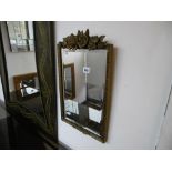 A GILT FRAMED MIRROR