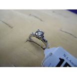 AN 18CT WHITE GOLD DIAMOND BRILLIANT CUT SOLITAIRE RING WITH DIAMOND SET SHOULDERS,