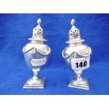 A PAIR OF GEORGIAN STYLE HALLMARKED SILVER PEPPER CASTERS A/F WEIGHT 7 TROY OUNCES