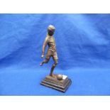 A BRONZE SCULPTURE OF A FOOTBALLER