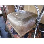 A LEATHER UPHOLSTERED FOOTSTOOL