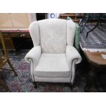 A BEIGE COLOUR WING ARMCHAIR OF CABRIOLE LEGS