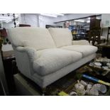 A WHITE UPHOLSTERED TWO SEATER SOFA