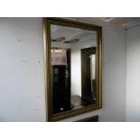 A GILT FRAMED MIRROR