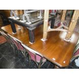 A 19TH CENTURY EXTENDING DINING TABLE WITH TWO LEAVES AND WINDER
