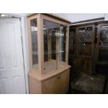 A DECORATIVE DESIGNER DISPLAY CABINET ON CUPBOARD BASE PLUS SIDE UNIT