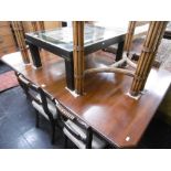 A 19TH CENTURY EXTENDING DINING TABLE WITH TWO LEAVES AND WINDER