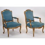 PAIRE DE FAUTEUILS EN BOIS DORE REGENCE En bois doré richement scupté à motifs de [...]