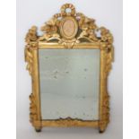 MIROIR LOUIS XVI En bois sculpté et doré, à fond vert. Frontont fleuri surmonté [...]