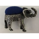 SILVER ELEPHANT PIN CUSHION - A silver elephant with blue cushioned back.