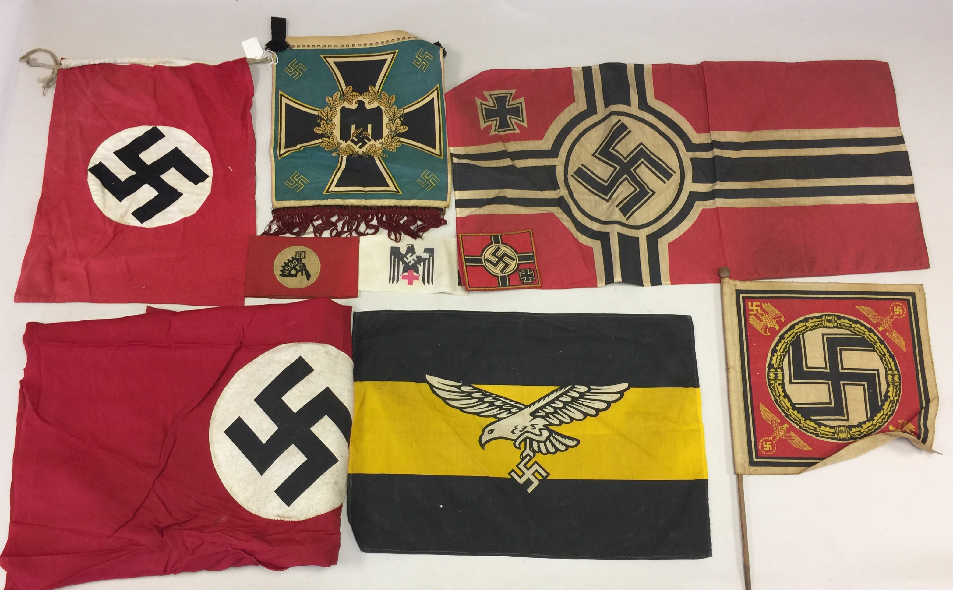 THIRD REICH FLAGS AND PENNANTS. 9 pieces to include flags, patches, armbands, and pennants.