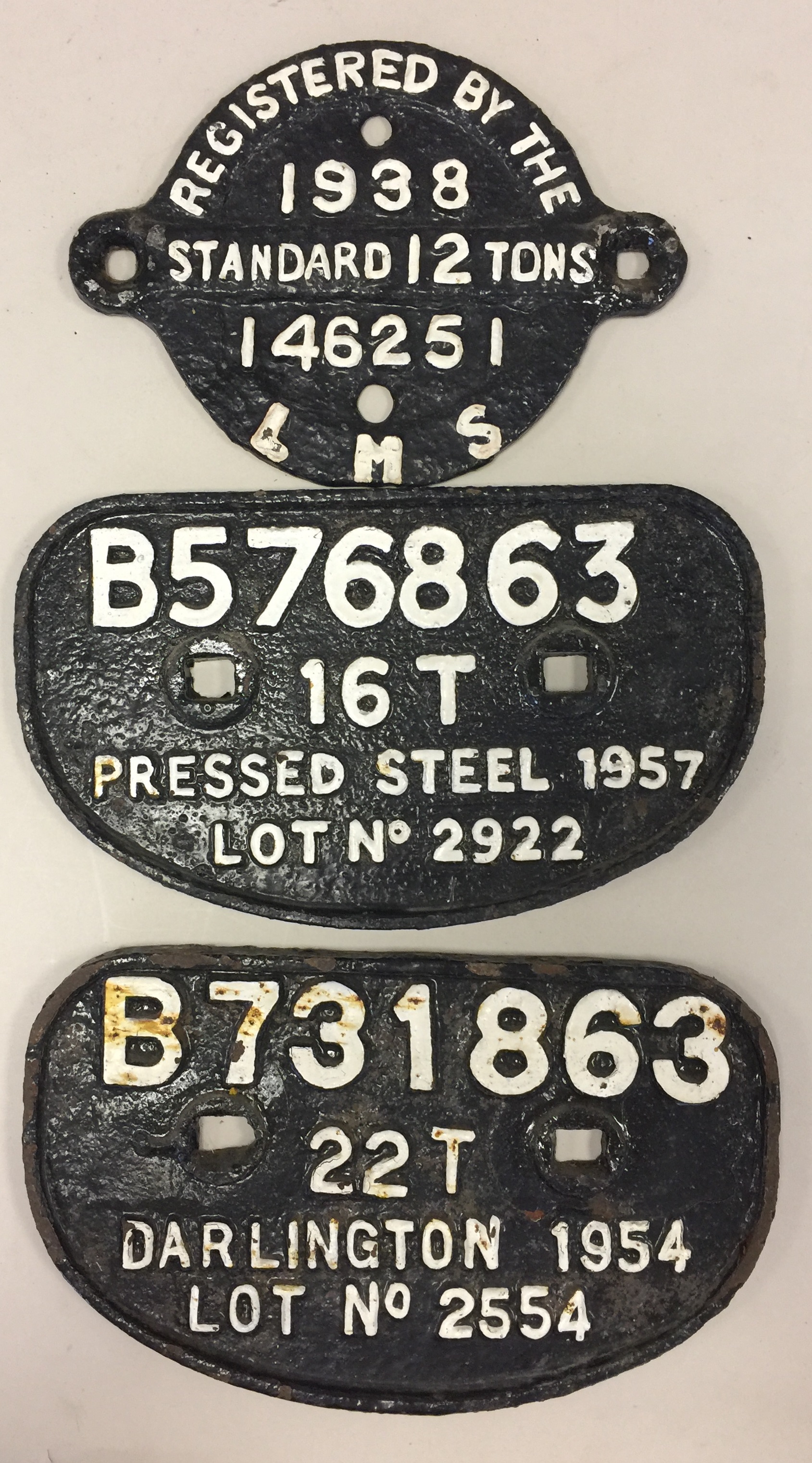 CAST IRON WAGON PLATES. Three original cast iron wagon plates.