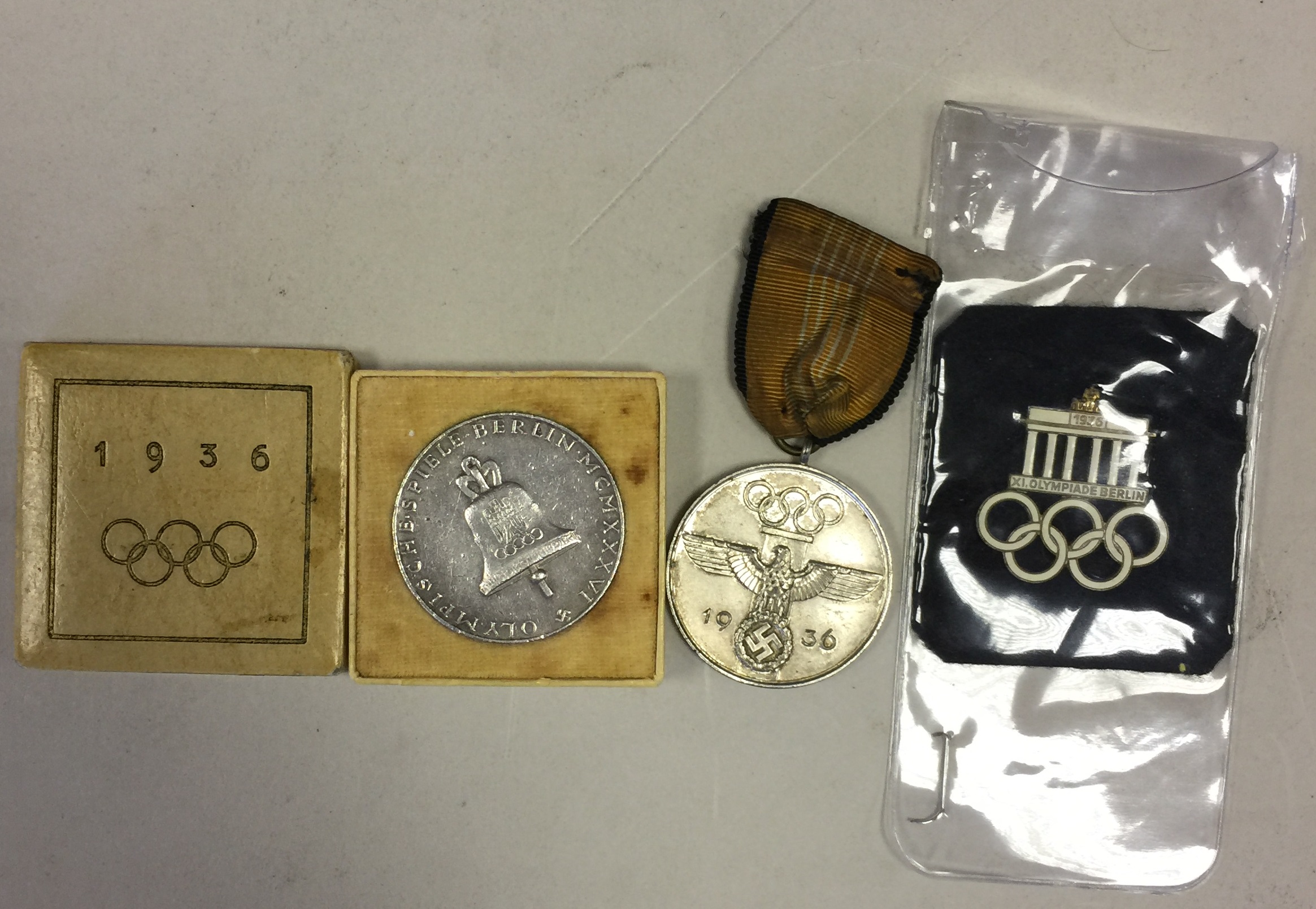 THIRD REICH. Two 1936 Olympic medals, one boxed and one with felt pouch, both commemorative issue.