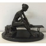 BENSON LANDES. (1927-2013) A sculpted figure of a seated ballerina in bronze.