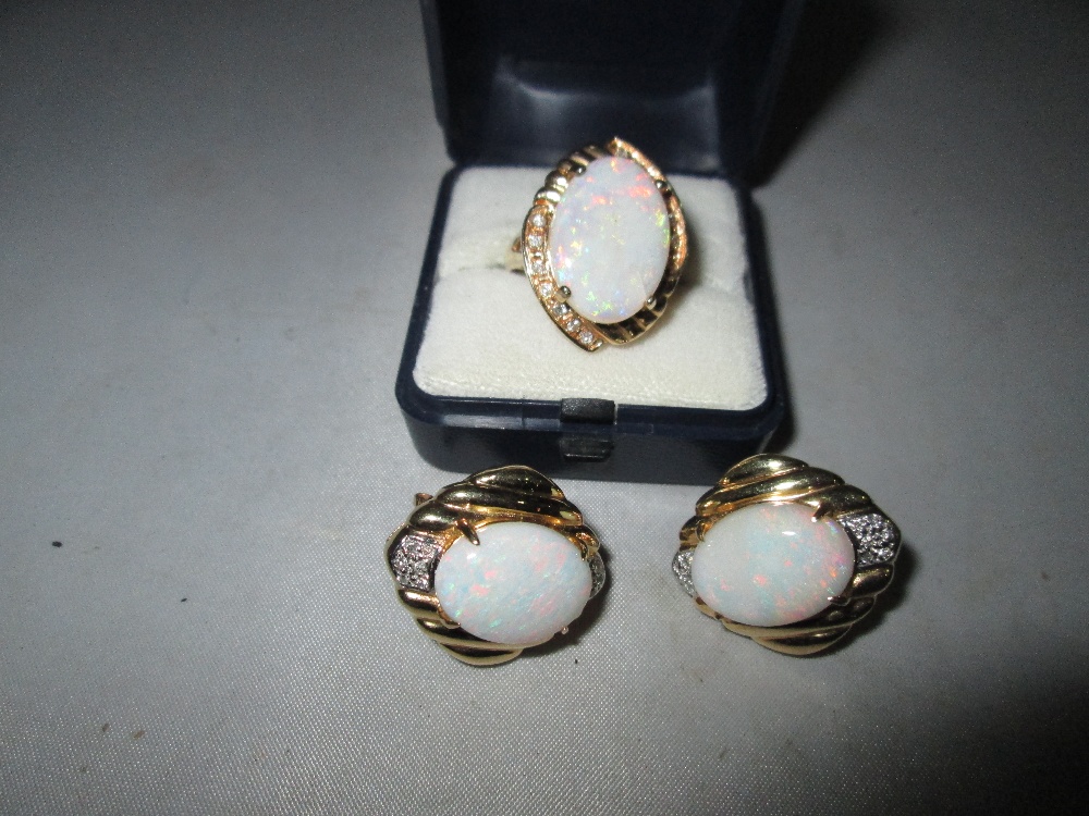 A good quality 20th century earring and ring set, comprising of three large opals (each 1.
