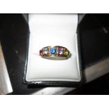 Modern 14 kt gold ring set with assorted multi coloured stones size 57 3 g
