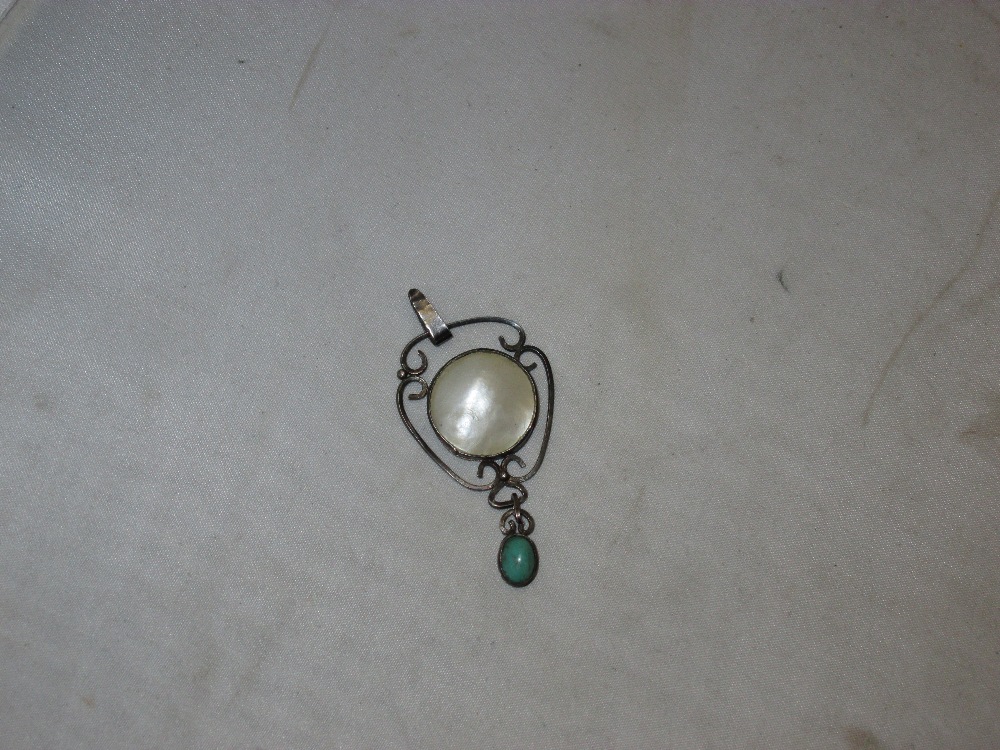 Pretty Art Nouveau pendant with mother of pearl and green hardstone in the style of Charles Horner