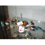 Shelf of decorative glass animal ornaments, Wade whimsies etc.