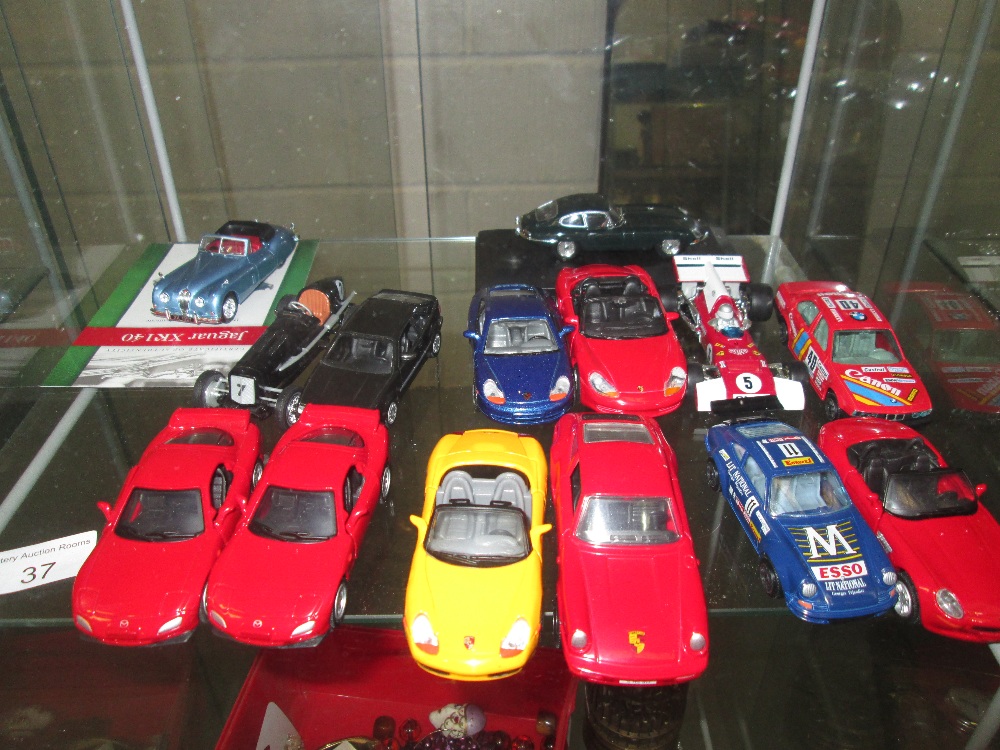 Shelf of collectors die cast toy cars : Atlas Editions Jaguar with certificate, Burago,