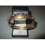Victorian unmarked but tested 14 ct + gold hinged bracelet set with four bright saphirres & three