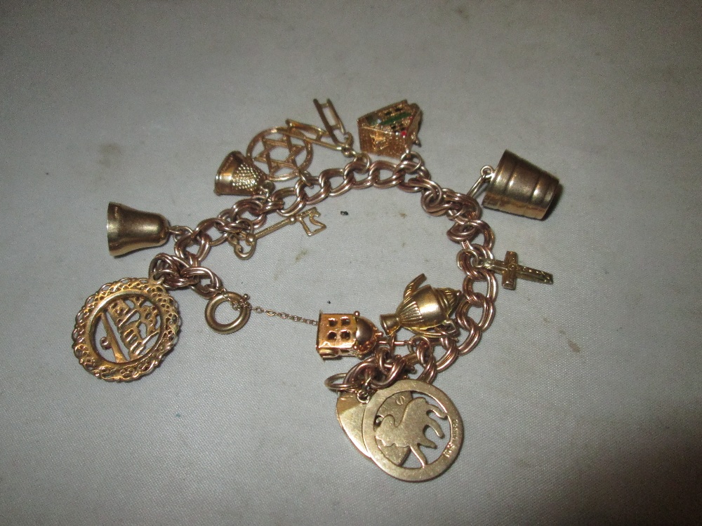 9 ct gold charm bracelet : bell, key, thimble, bucket,