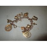 9 ct gold charm bracelet : bell, key, thimble, bucket,